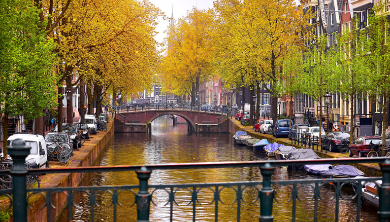 Beautiful Amsterdam canal river Amstel with traditional houses